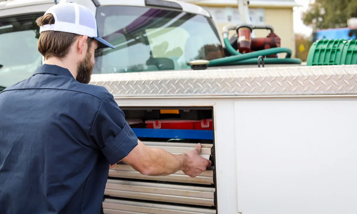 HomeField technician opening a stocked parts drawer on a service truck