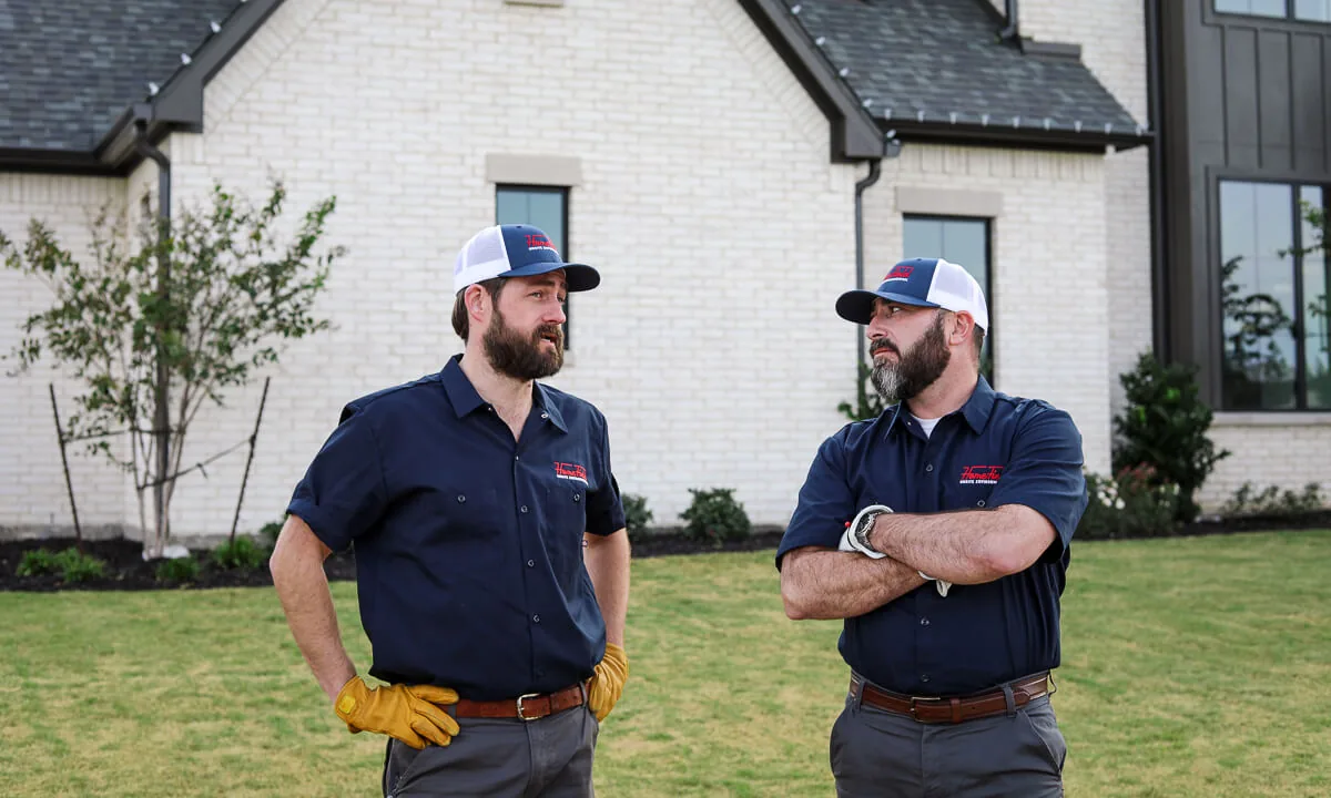 Two HomeField crew members talking outside a customer's home